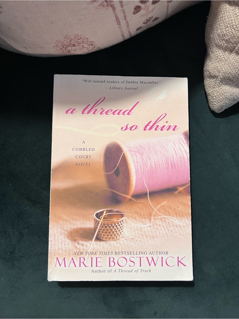 A Thread So Thin by Marie Bostwick - Pink Sewing-Themed Paperback